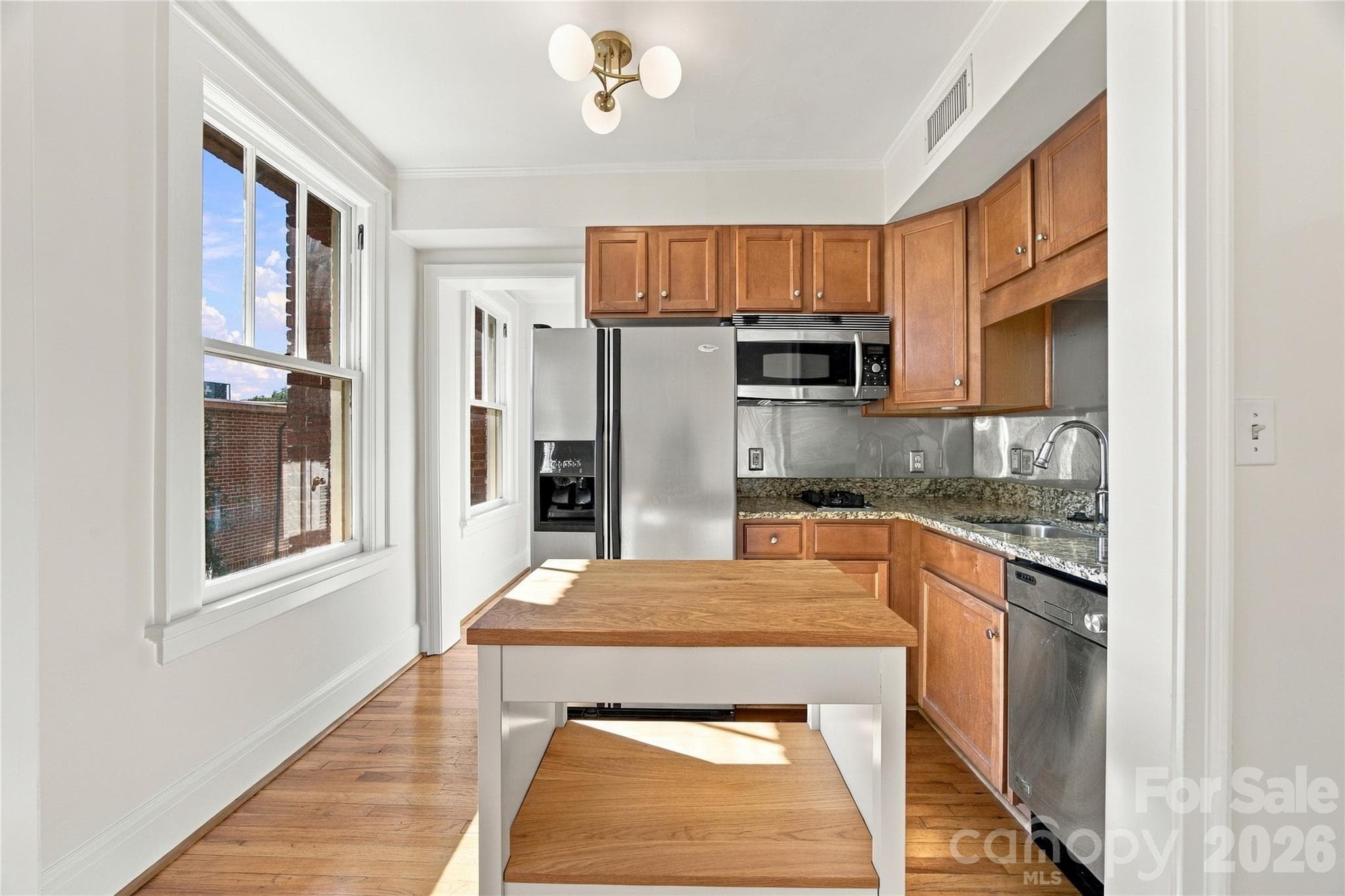 Kitchen - Small footprint, big function - full-size fridge, dishwasher, and an island that stays. - 712 Louise Avenue, Charlotte
