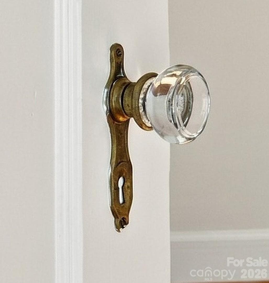 Crystal doorknobs - a little sparkle among the charming details found throughout. - 712 Louise Avenue, Charlotte