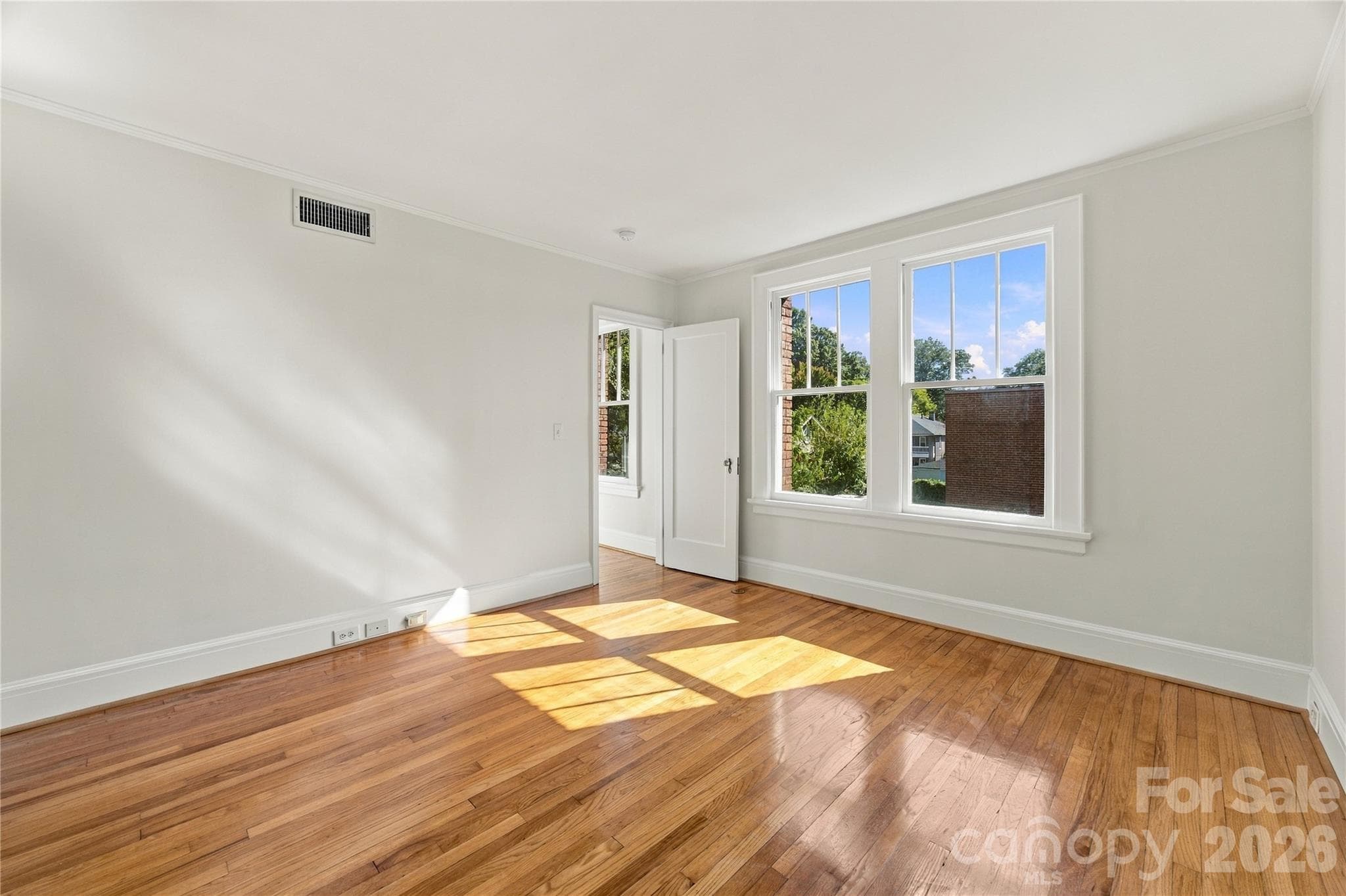 Primary bedroom - Bring the king bed! Space for your bedroom furniture, a generous walk-in closet, and an en suite bath. - 712 Louise Avenue, Charlotte