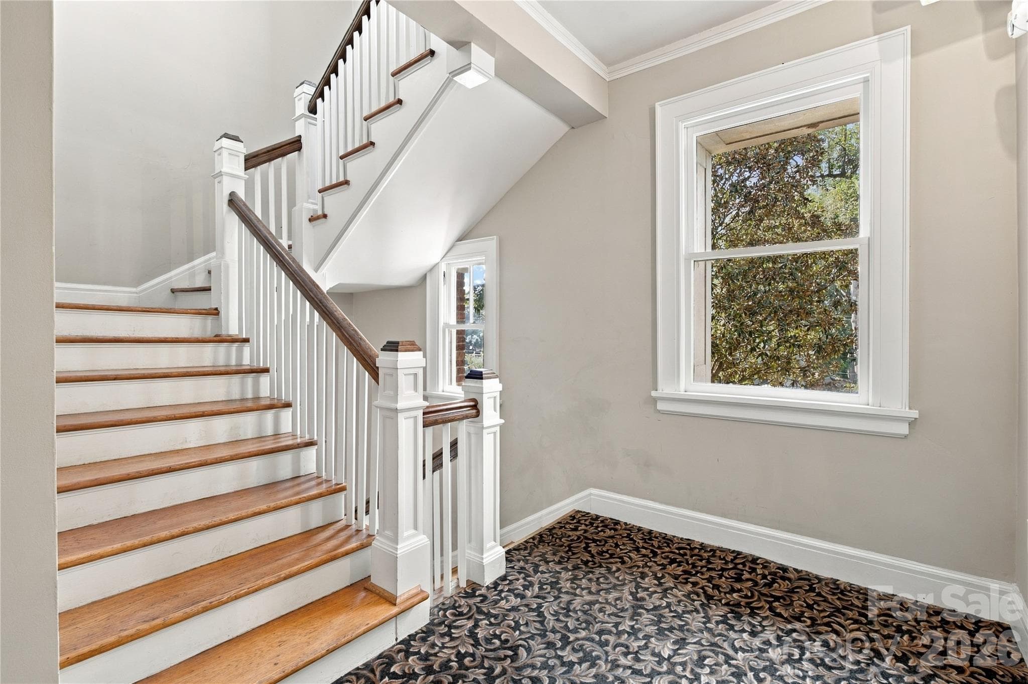 The second-floor staircase showcases the architectural charm that makes The Rutzler special. - 712 Louise Avenue, Charlotte
