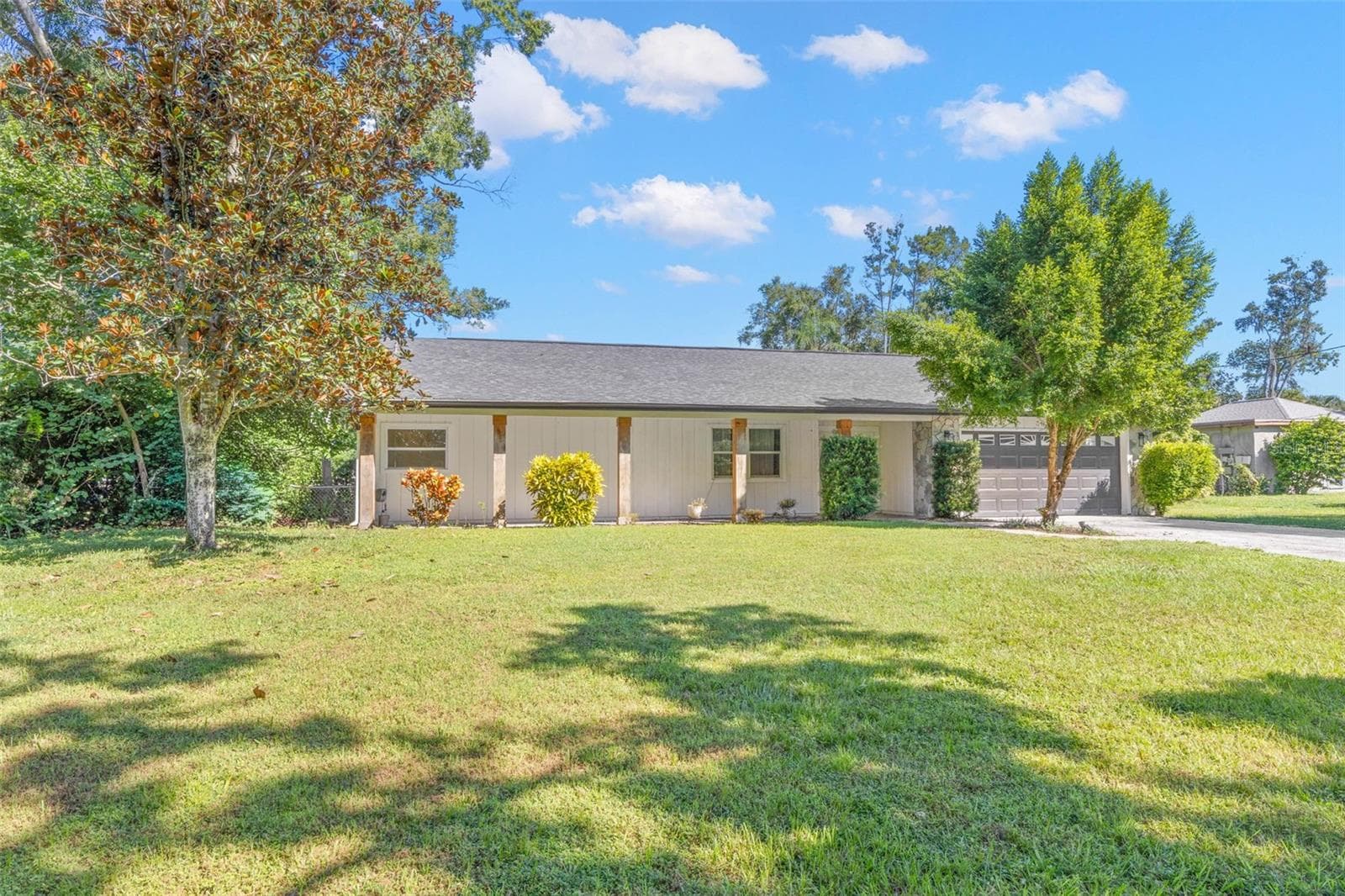 Set on a spacious .34-acre lot, this attractive single-story home features a sweeping front lawn, mature shade trees, established landscaping, and a welcoming covered front porch. - 3013 GRAHAM LN, TAMPA