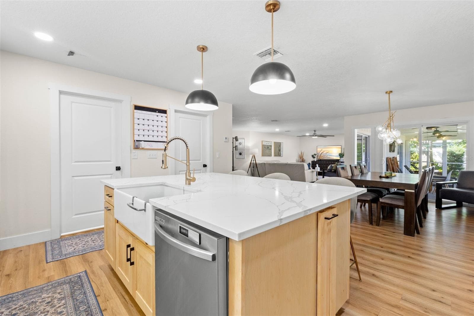 Designed with entertaining in mind, the impressive center island features a farmhouse-style apron-front sink, built-in dishwasher, ample workspace, and additional storage. The open layout keeps the kitchen connected to the dining and living areas, making everyday gatherings effortless. - 3013 GRAHAM LN, TAMPA