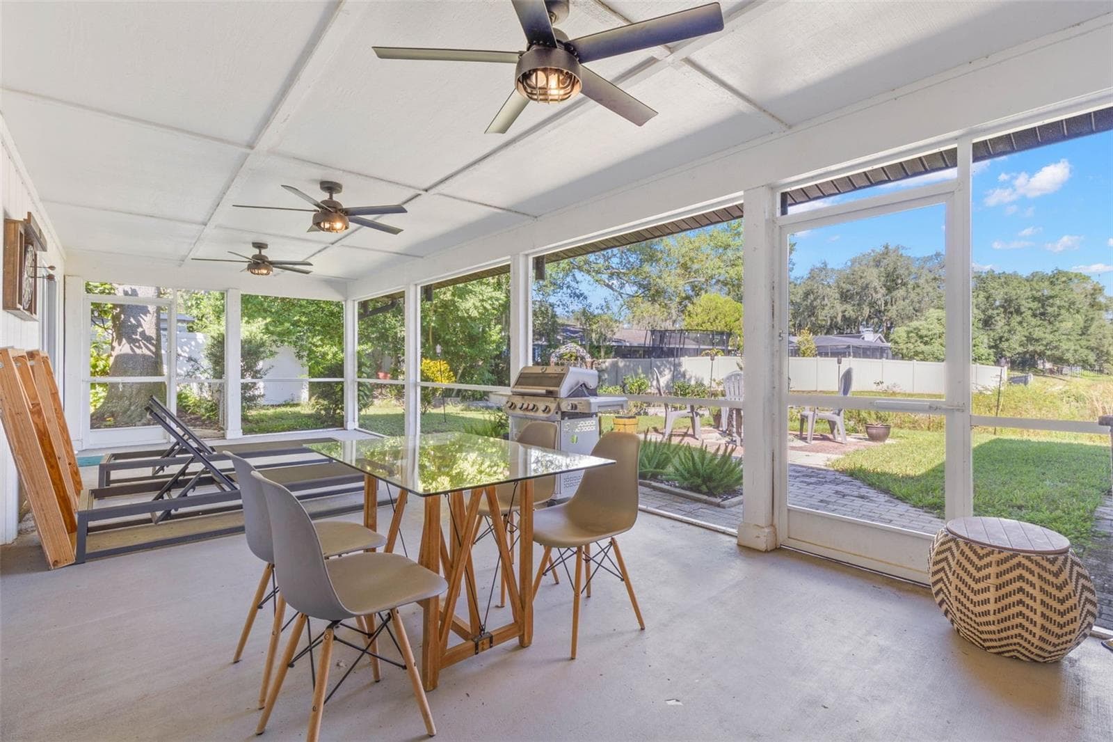 Enjoy outdoor dining year-round on the expansive screened porch, complete with three ceiling fans, room for comfortable seating, and a convenient screen door leading to the backyard and adjoining patio. An ideal setting for casual meals, entertaining, or simply enjoying the fresh air. - 3013 GRAHAM LN, TAMPA
