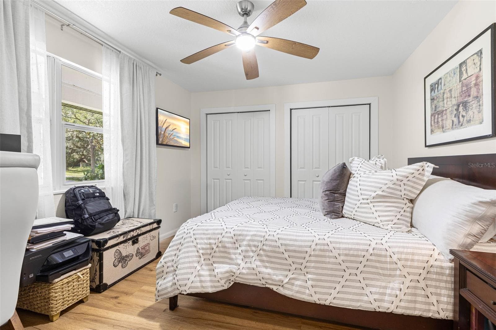 Bedroom four features two closets for ample storage, wood-look luxury vinyl flooring, a modern ceiling fan, and a window overlooking the front yard. A versatile room equally suited for guests, a home office, or a personal retreat. - 3013 GRAHAM LN, TAMPA