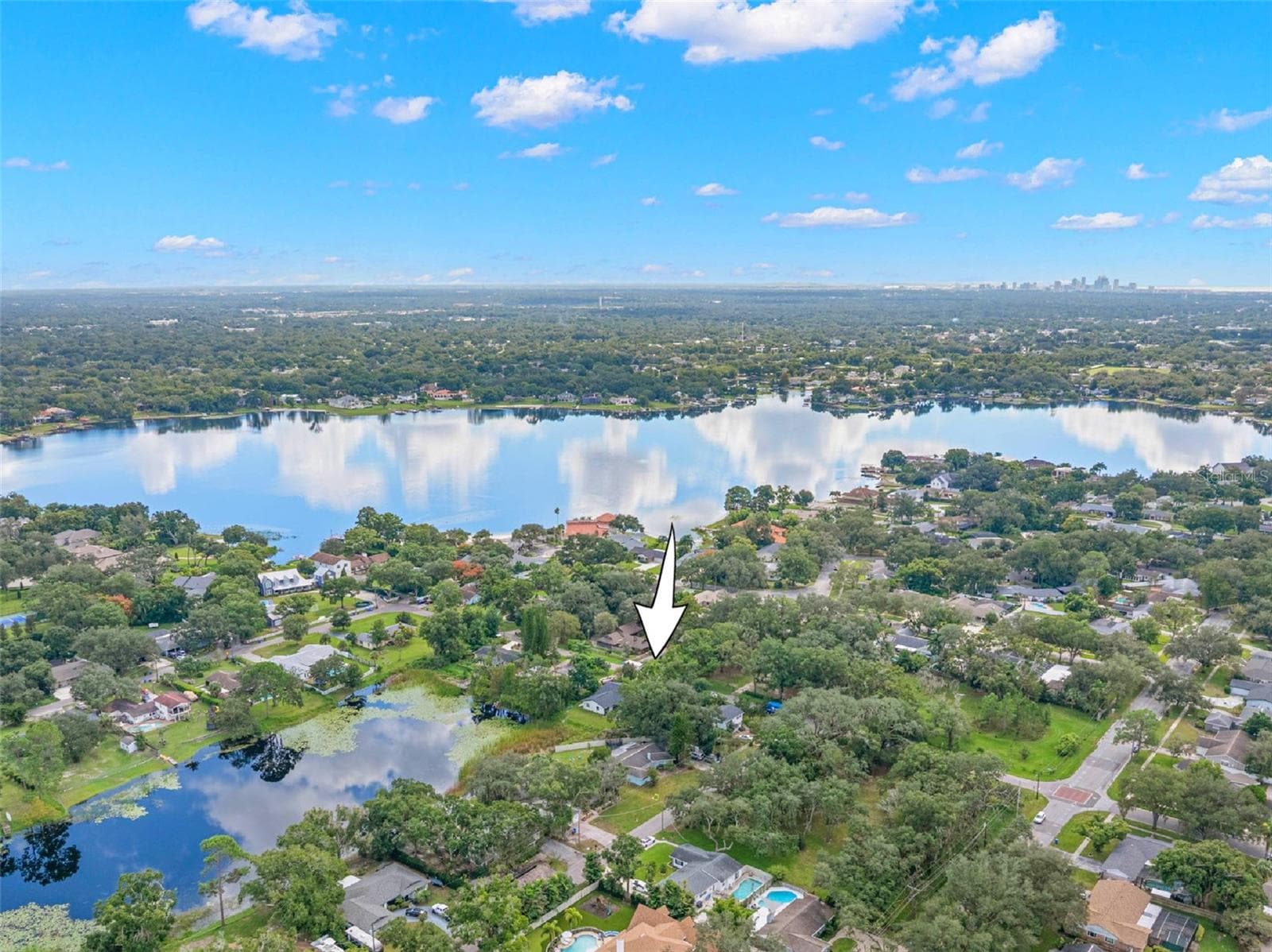 Discover the charm of Carrollwood from above! This aerial perspective highlights the property's location in an established, tree-lined neighborhood, surrounded by scenic lakes and residential streets, with convenient access to North Dale Mabry Highway and the greater Tampa area. - 3013 GRAHAM LN, TAMPA