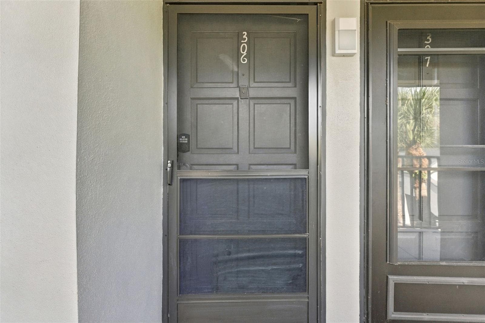 Front door to your unit just steps from the elevator on the 3rd floor - 2650 COUNTRYSIDE BLVD #A306, CLEARWATER