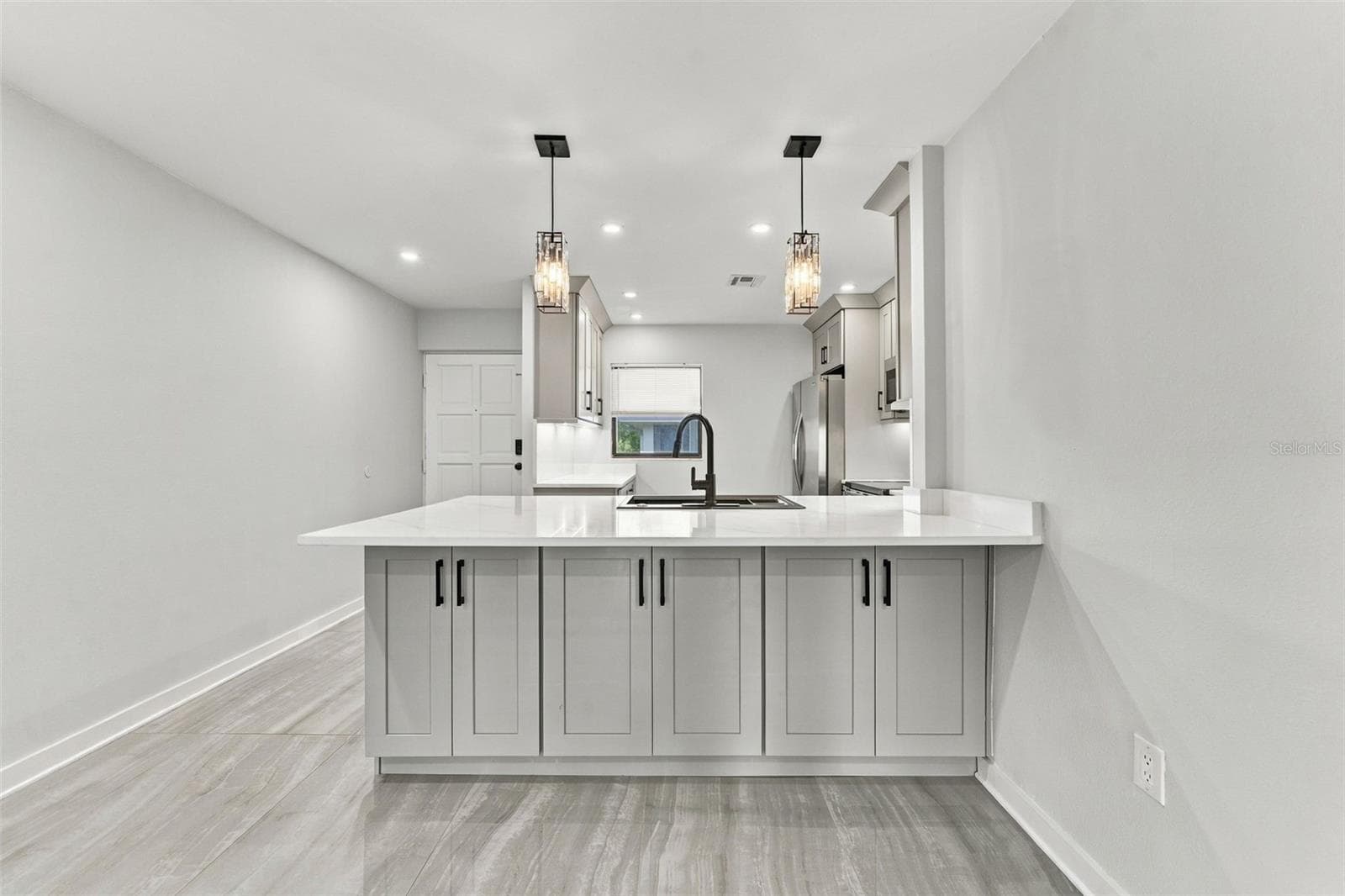 Bar seating in kitchen with additional under counter storage - 2650 COUNTRYSIDE BLVD #A306, CLEARWATER