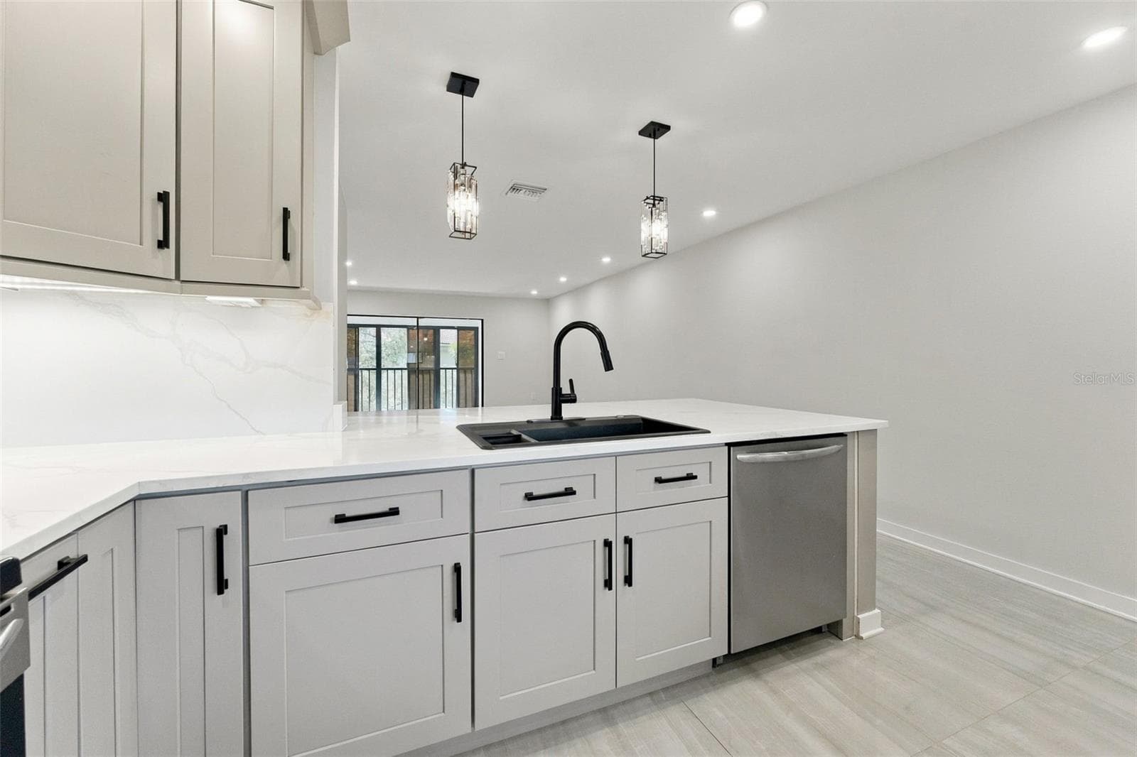 All-new LED can lighting with stylish pendant lights over the kitchen bar - 2650 COUNTRYSIDE BLVD #A306, CLEARWATER