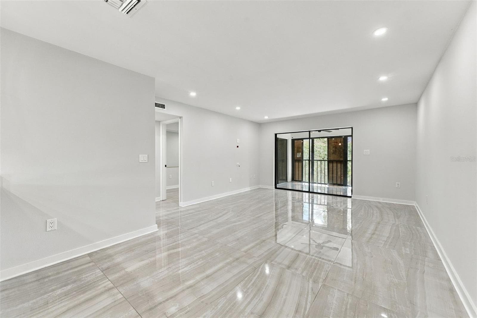 Dining area flows seamlessly into the inviting living room - 2650 COUNTRYSIDE BLVD #A306, CLEARWATER