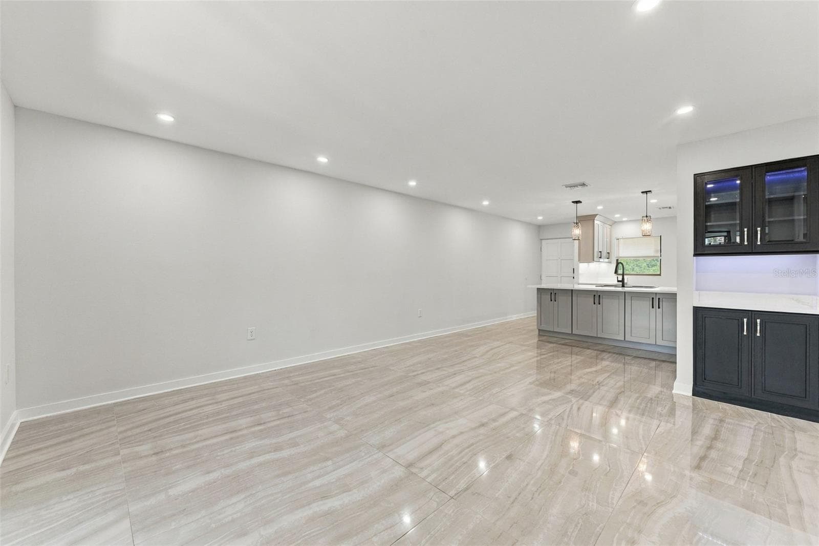 View from the living room showcasing the open dining area and kitchen - 2650 COUNTRYSIDE BLVD #A306, CLEARWATER