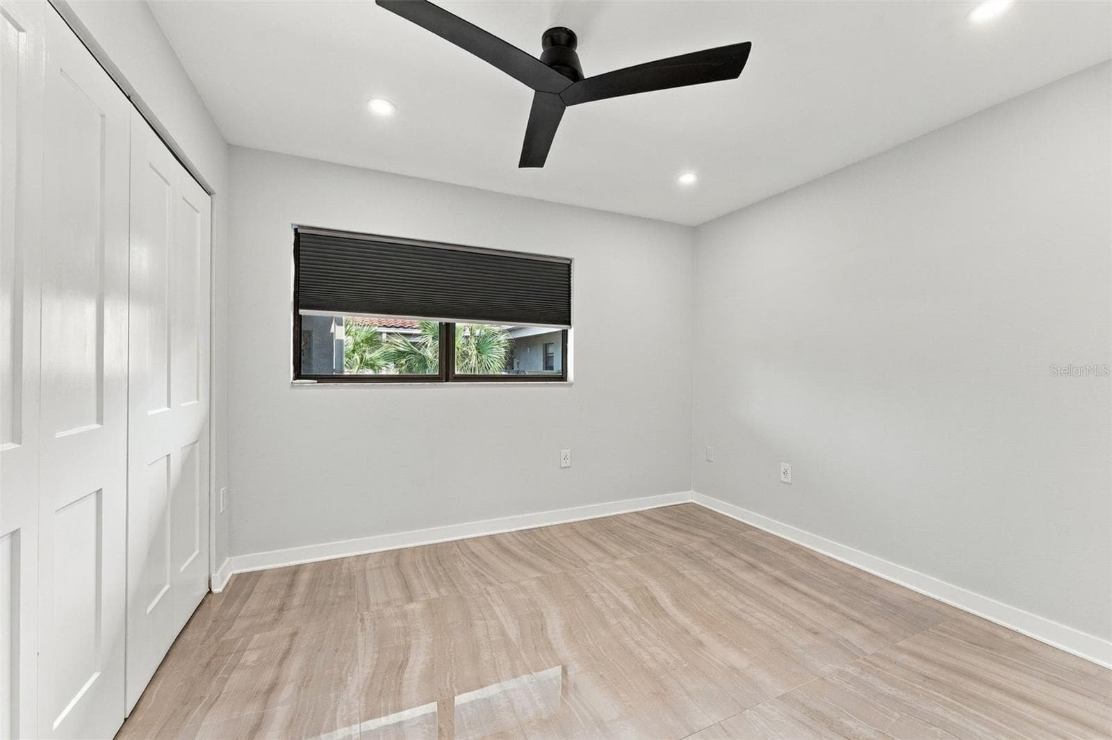Bedroom two with new flooring, lighting and ceiling fan - 2650 COUNTRYSIDE BLVD #A306, CLEARWATER