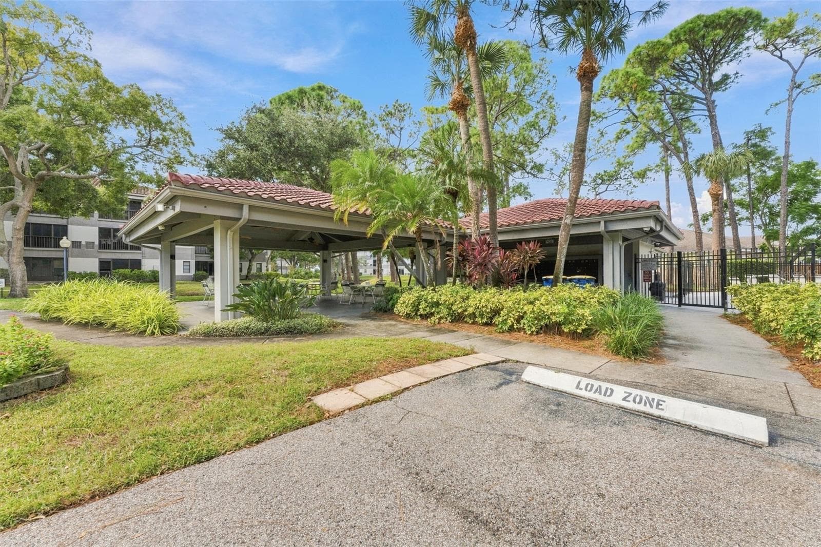 Outdoor covered seating area located by the community pool - 2650 COUNTRYSIDE BLVD #A306, CLEARWATER