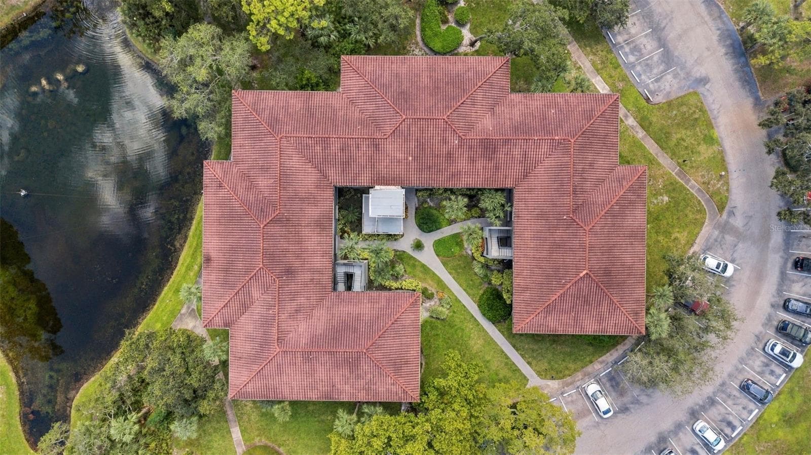 Aerial view showcasing the well-maintained building and roof - 2650 COUNTRYSIDE BLVD #A306, CLEARWATER