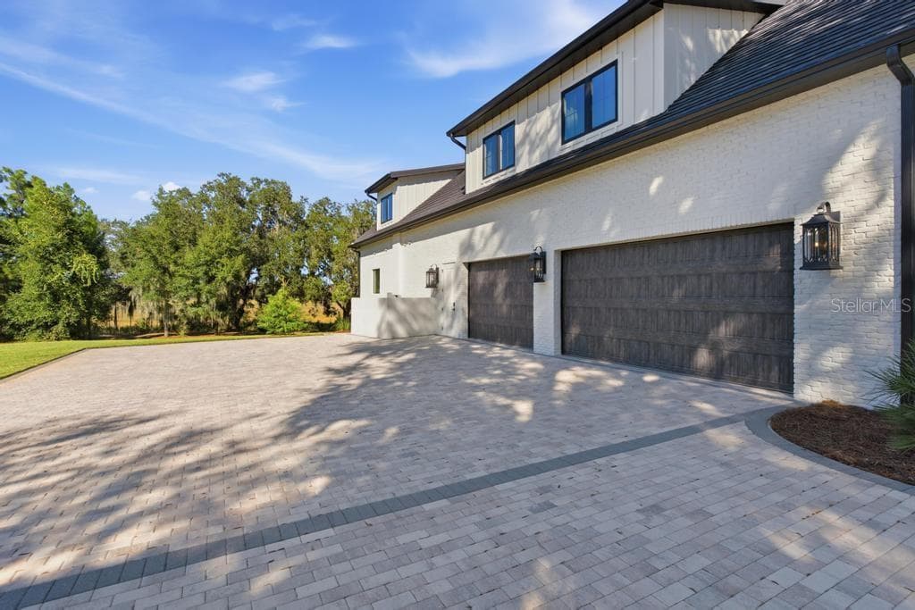 Room for all your cars and toys  with extra brick paver driveway - 467 LONG AND WINDING RD, HOWEY IN THE HILLS