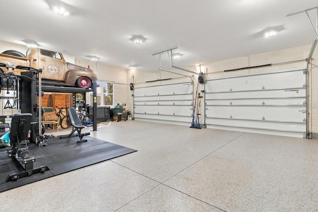 Huge 3 Car Garage Nearly 1100 Sqft... enjoy epoxy floors and bright LED lighting! - 467 LONG AND WINDING RD, HOWEY IN THE HILLS