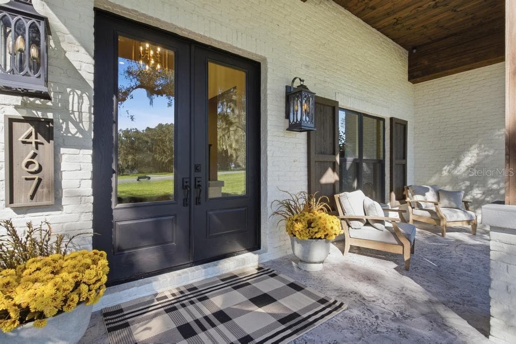 Charming covered porch ... Love this custom double door entrance! - 467 LONG AND WINDING RD, HOWEY IN THE HILLS