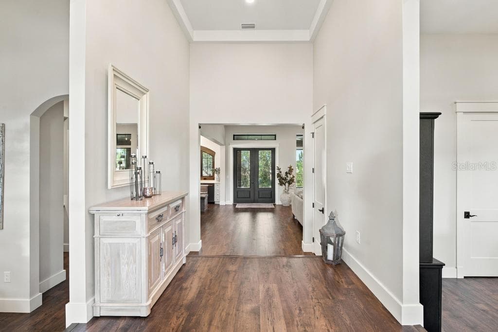 Light filled foyer leads to den/office and great room - 467 LONG AND WINDING RD, HOWEY IN THE HILLS
