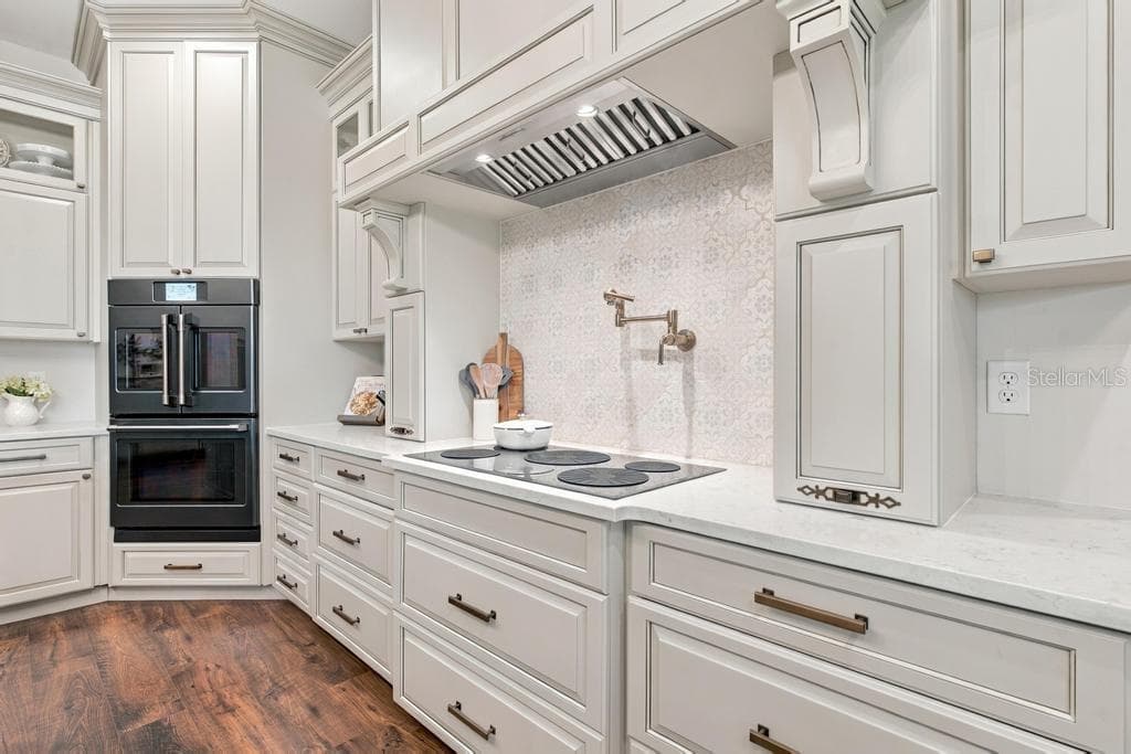 Kitchen with handmade tile backsplash and convenient pot filler - 467 LONG AND WINDING RD, HOWEY IN THE HILLS