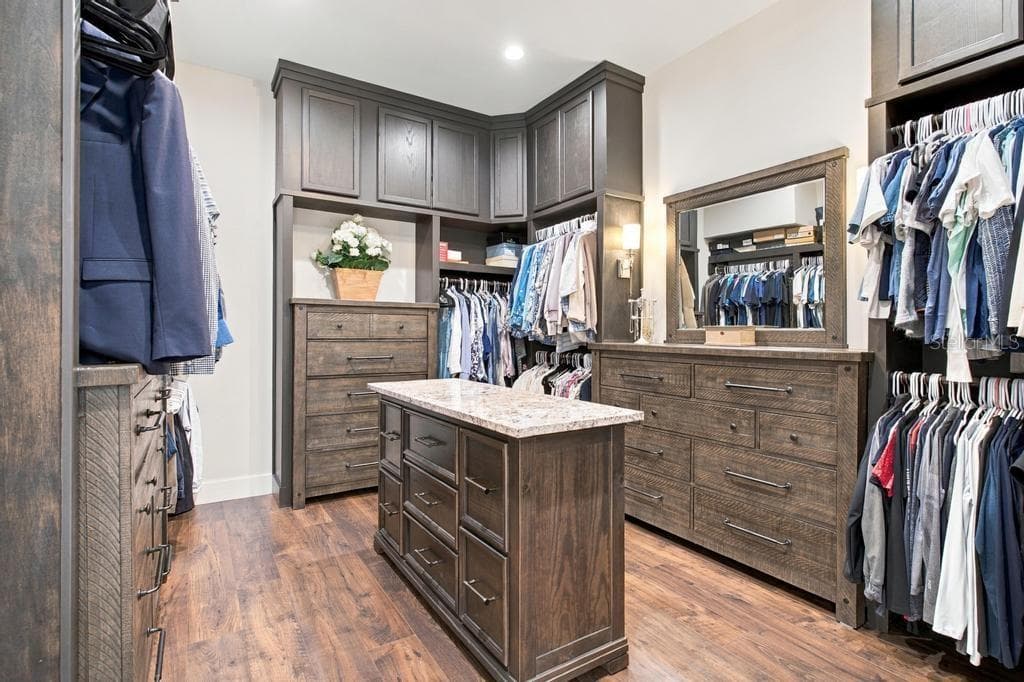 Spacious custom closet with island and built-in furniture - 467 LONG AND WINDING RD, HOWEY IN THE HILLS