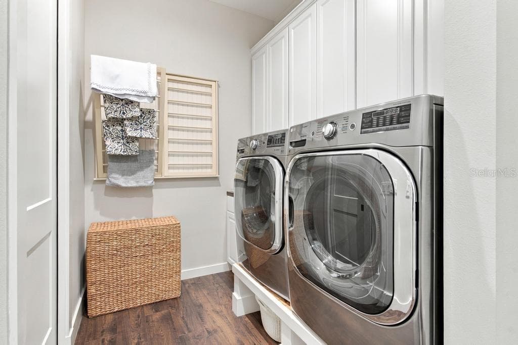 Inside laundry room #1 with built in iron board, sink, and access to walk-in closet - 467 LONG AND WINDING RD, HOWEY IN THE HILLS