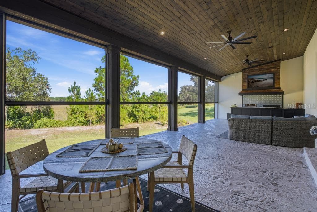 Back porch with view of the lake and nature - 467 LONG AND WINDING RD, HOWEY IN THE HILLS