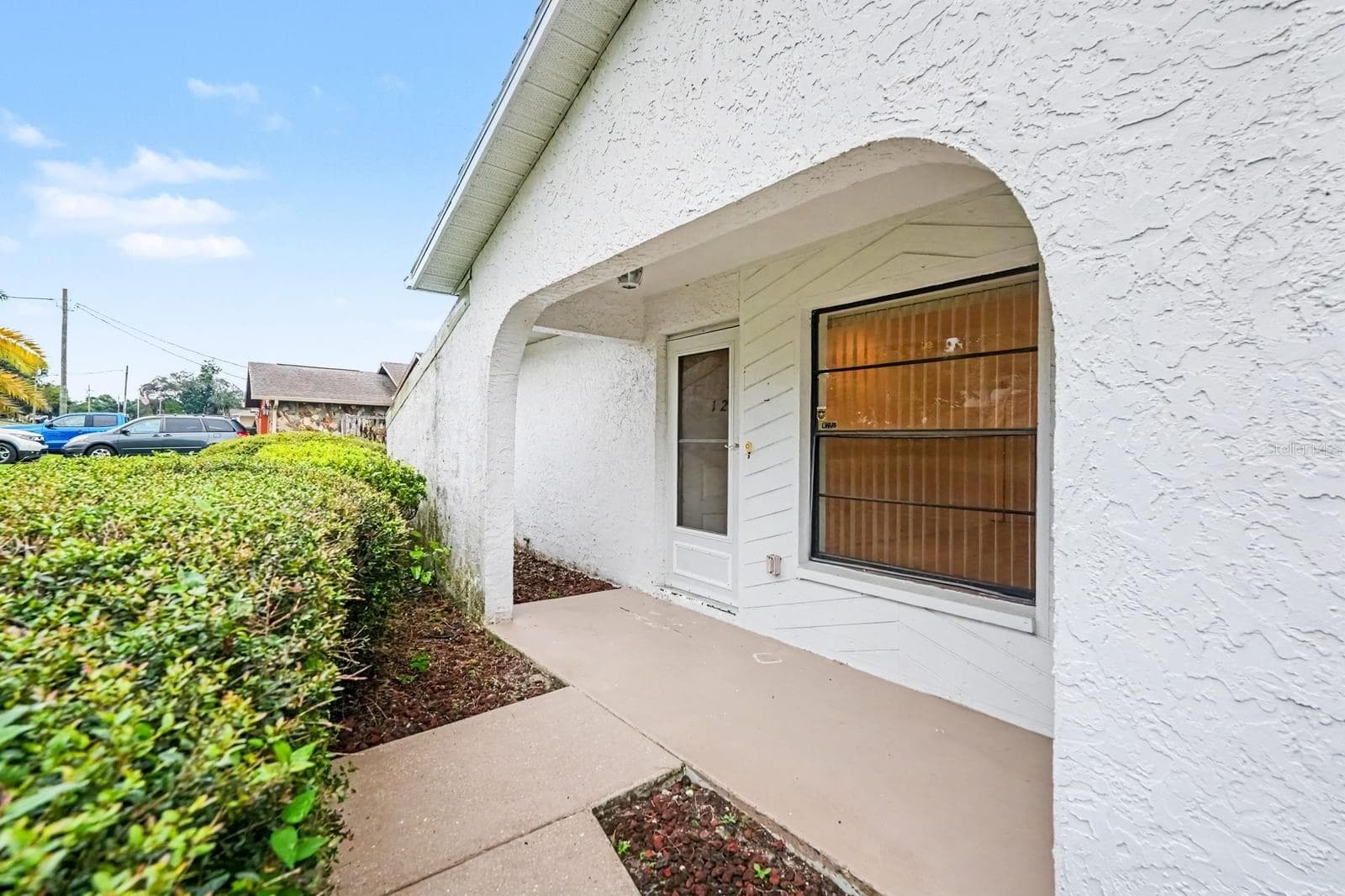 Covered Entryway with Arched Design and Wood-Look Garage Door - 12128 KATHERWOOD ST #20, SPRING HILL