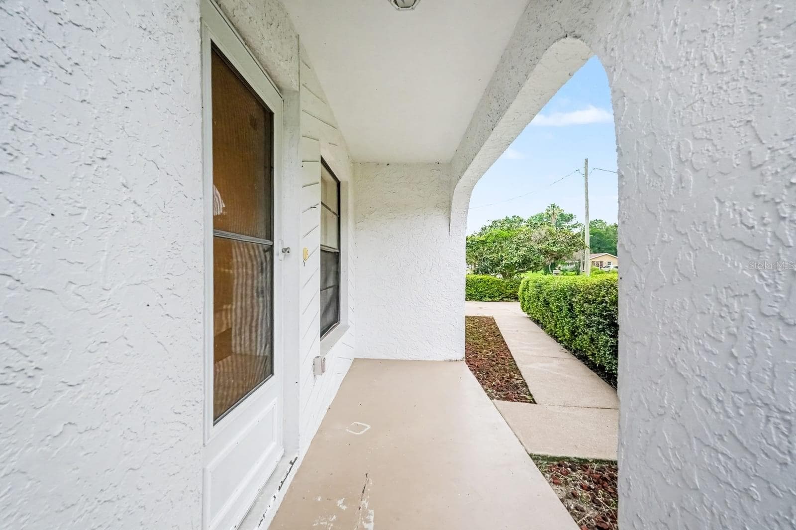 Covered Porch with Double Doors Opens to Manicured Grounds - 12128 KATHERWOOD ST #20, SPRING HILL