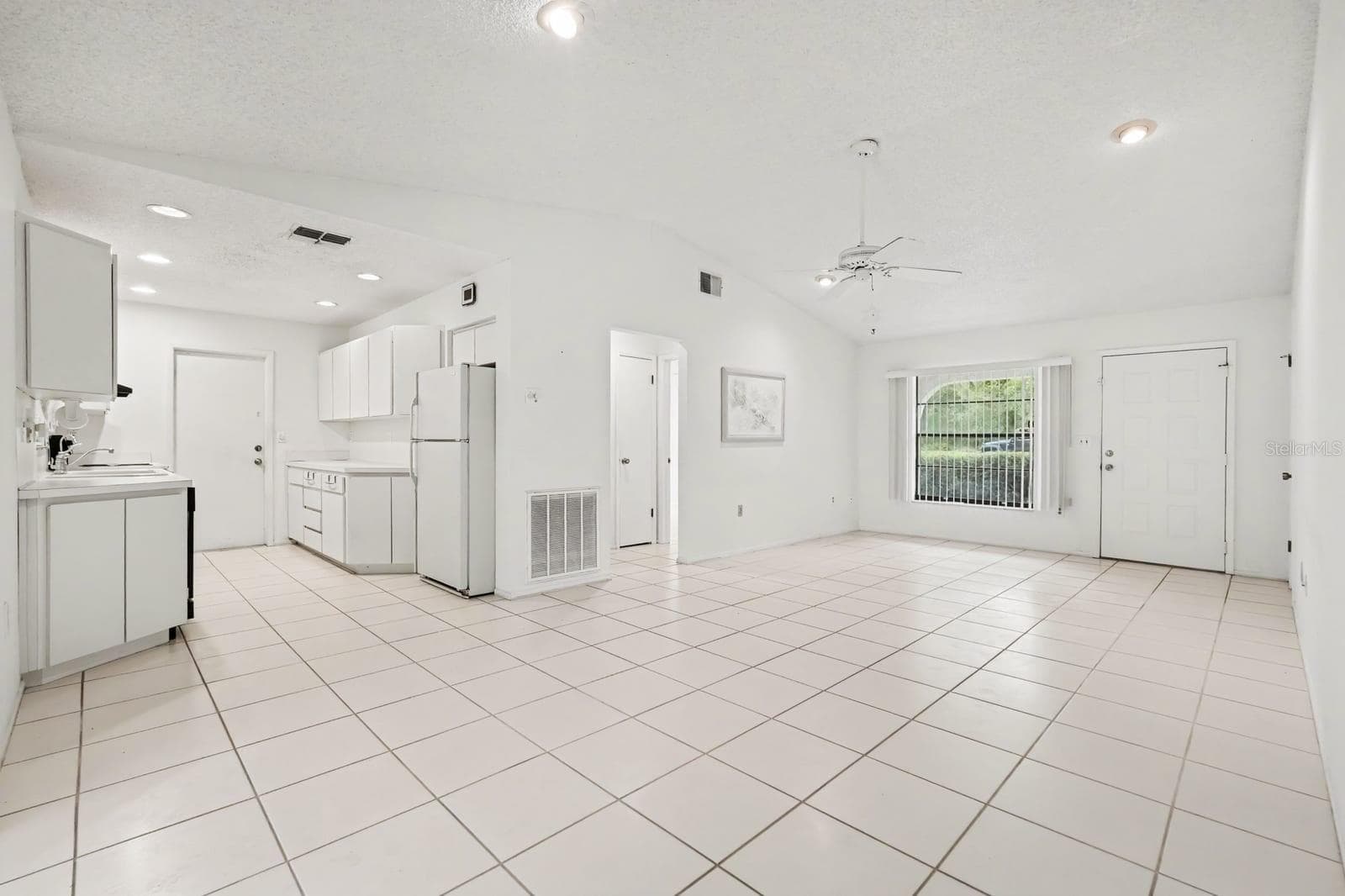 Open Concept Kitchen and Living Area with Tile Flooring and Sliding Doors - 12128 KATHERWOOD ST #20, SPRING HILL