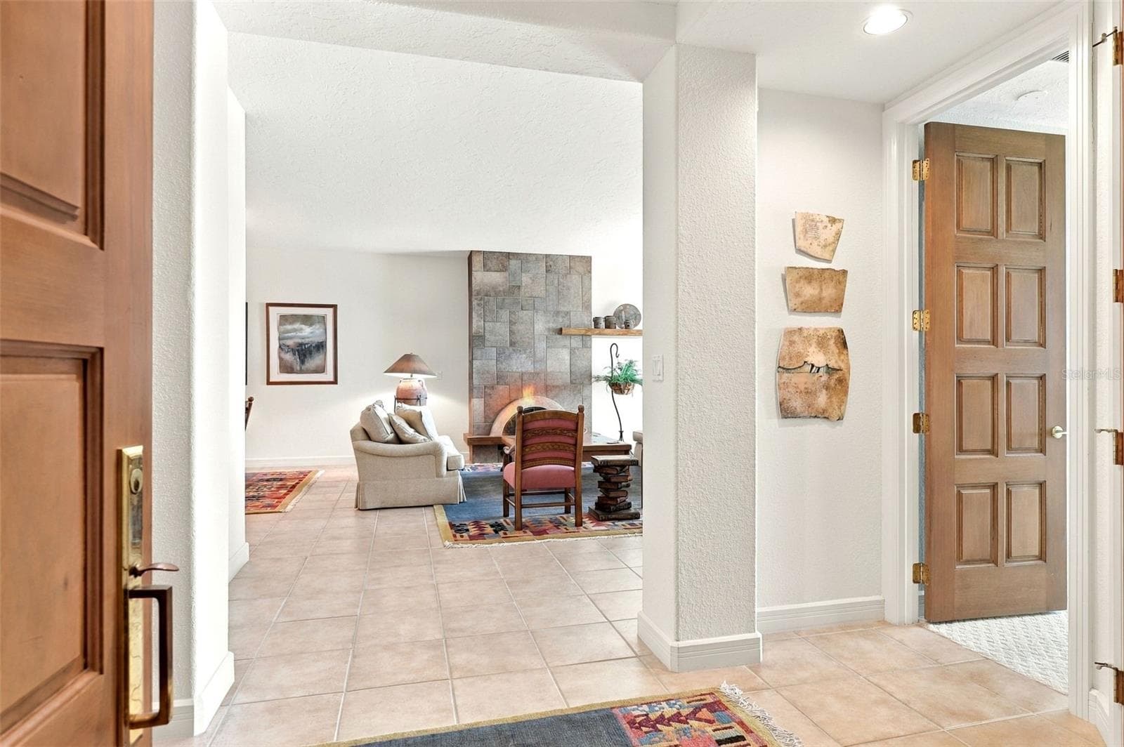 The foyer opens up to the main living area, the primary suite and the kitchen. - 2185 GULF OF MEXICO DR #243, LONGBOAT KEY