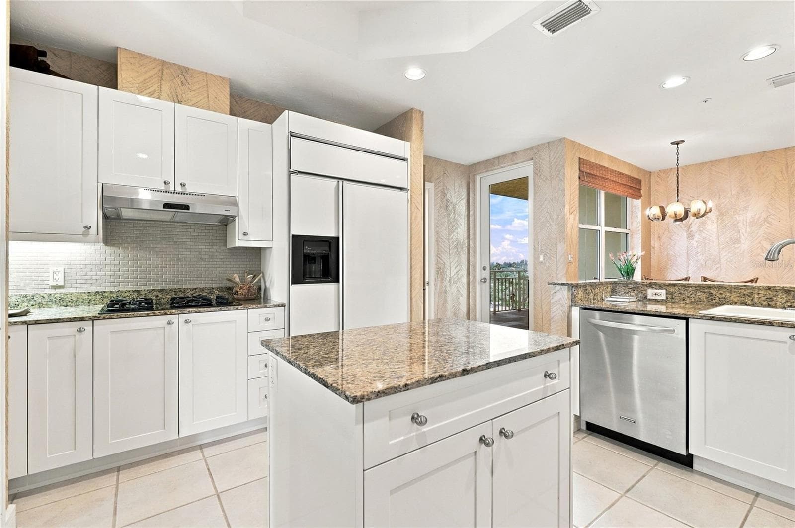 Cooktop with natural gas, under cabinet lighting and mini subway tile backsplash. - 2185 GULF OF MEXICO DR #243, LONGBOAT KEY