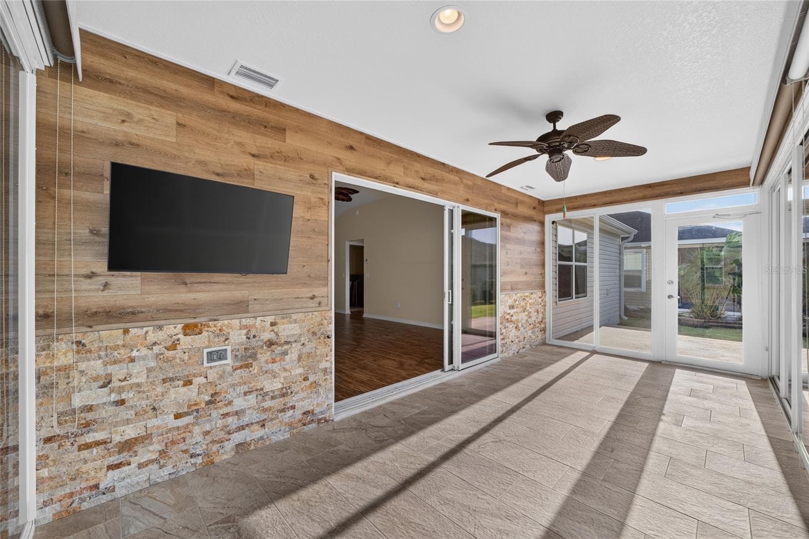CUSTOM WALL with Stone & Laminate Planks, Mounted TV - 3552 WYNGATE PL, THE VILLAGES