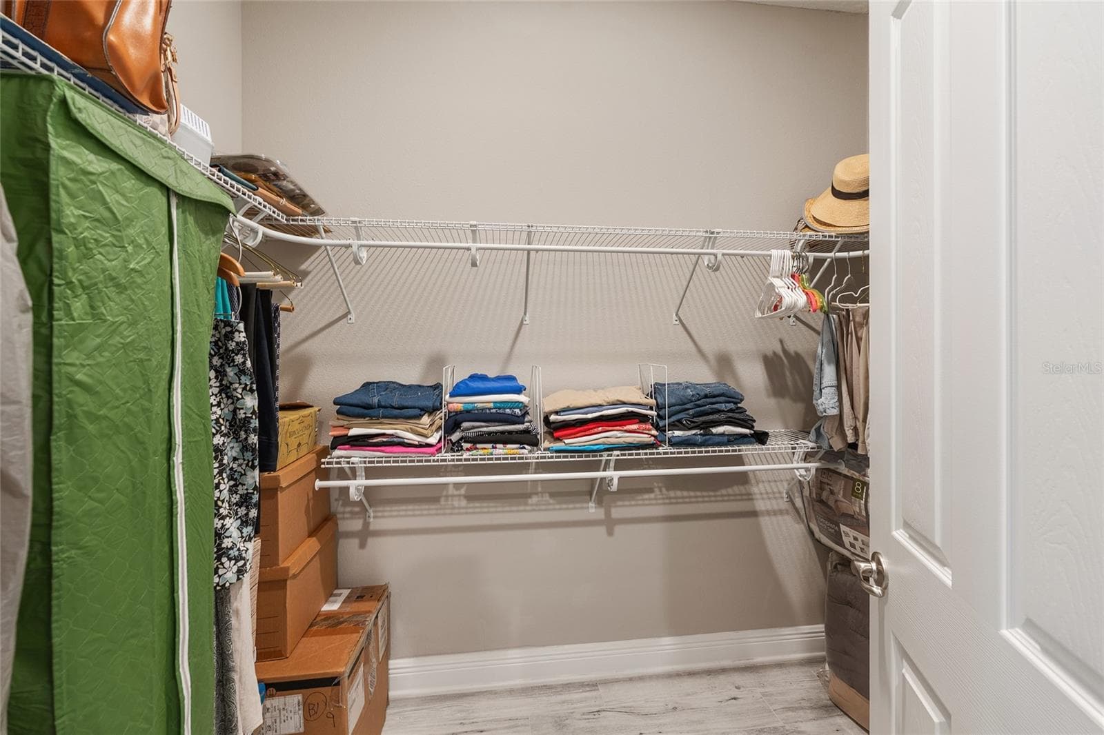 Second walk-in closet in the primary suite, offering additional shelving and hanging space to keep clothing and accessories neatly organized. - 8290 SW 92ND CIR, OCALA
