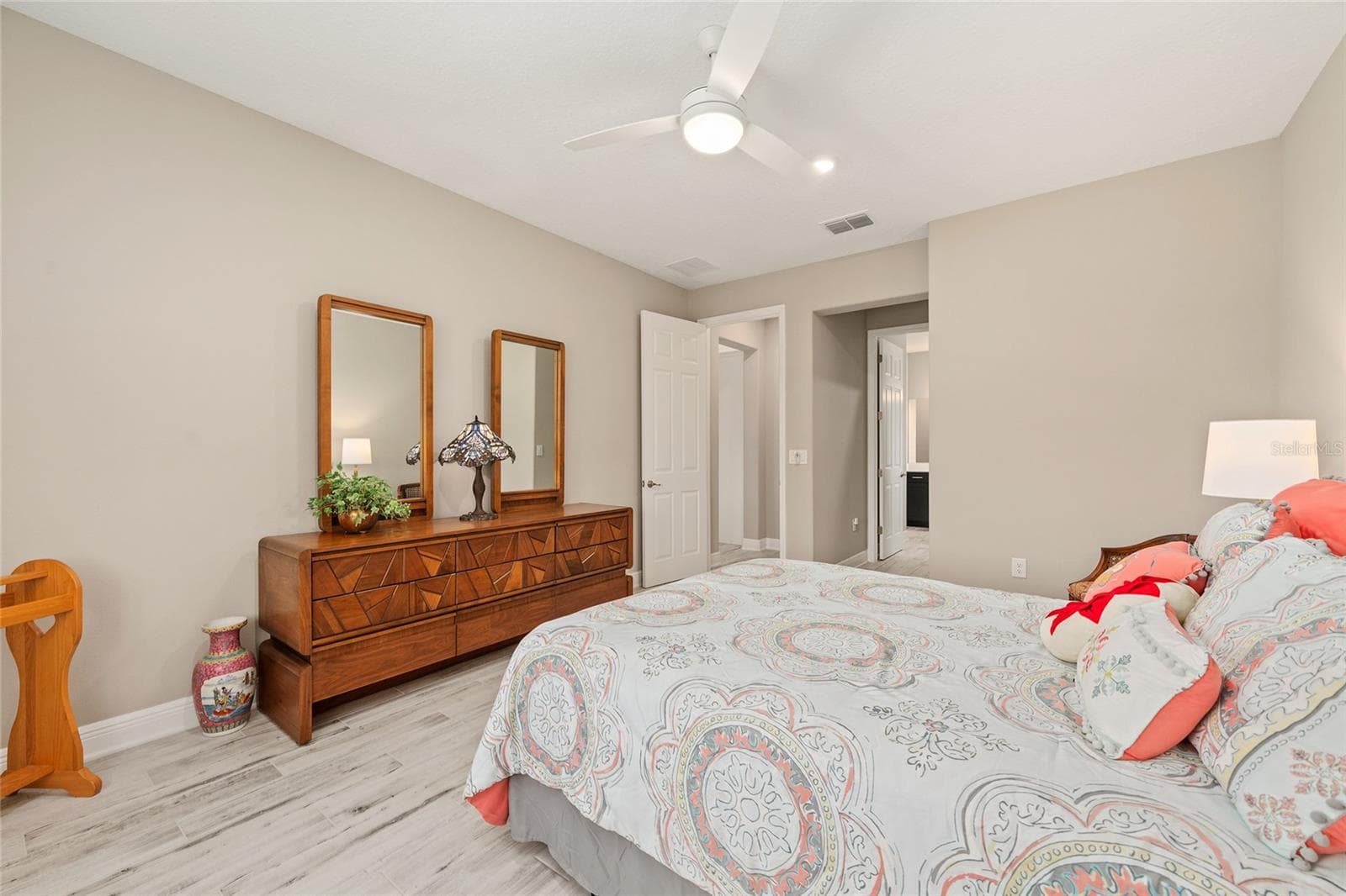 Another view of the spacious second primary suite, highlighting a convenient alcove and direct access to the private ensuite bathroom, offering a comfortable and functional retreat. - 8290 SW 92ND CIR, OCALA