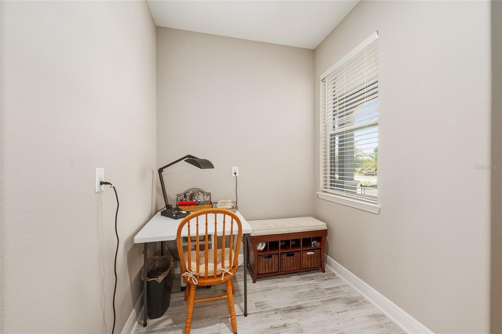Versatile bonus space conveniently located off the two-car garage and near the pantry, offering the perfect spot for a secondary home office, hobby area, or organized everyday drop zone. - 8290 SW 92ND CIR, OCALA