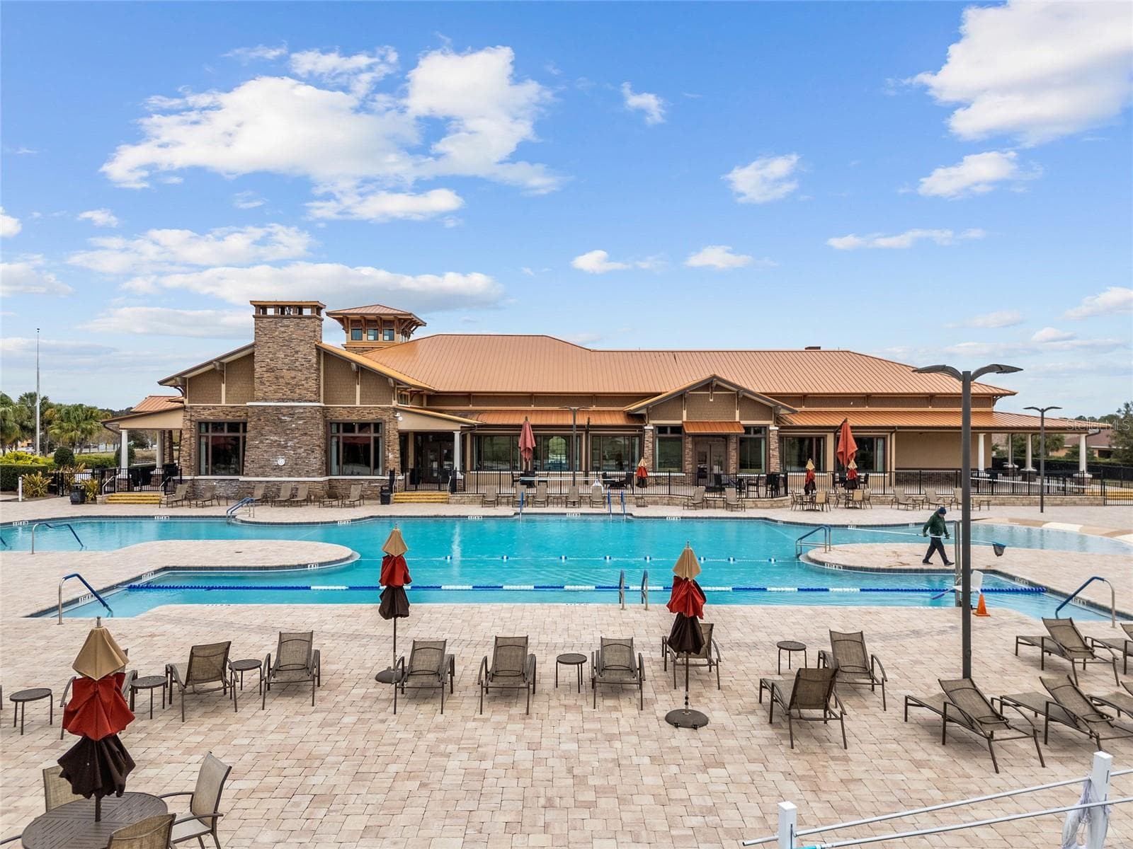 Enjoy resort-style living at the Candler Hills heated swimming pool, featuring dedicated lap lanes, beach-entry access, an expansive pool deck, and plenty of lounge seating. The beautiful setting overlooking The Lodge offers the perfect place for swimming, relaxation, and socializing. - 8290 SW 92ND CIR, OCALA