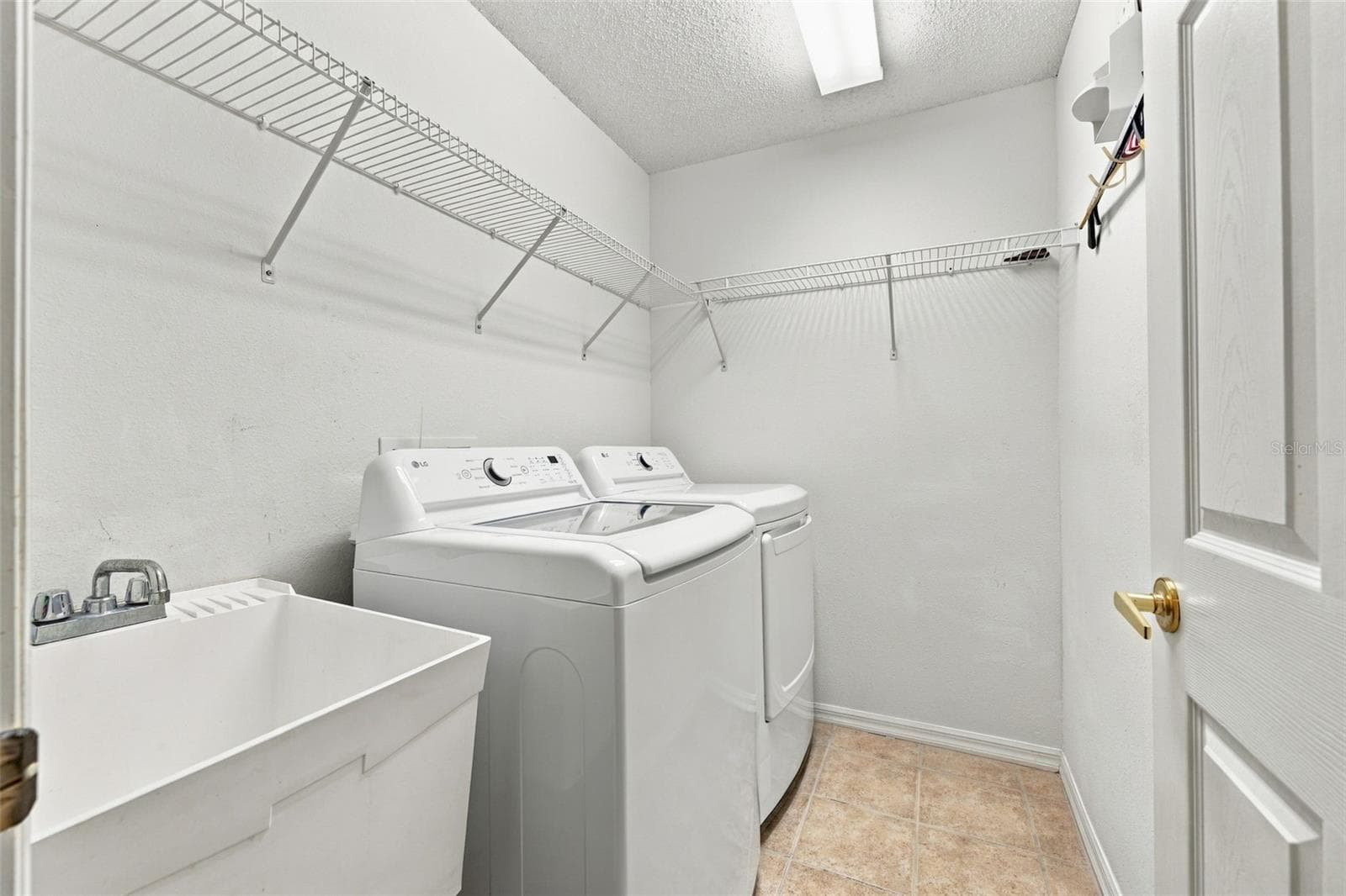 Indoor laundry area with sink and storage - 1149 WOLFORD DR, NEW PORT RICHEY