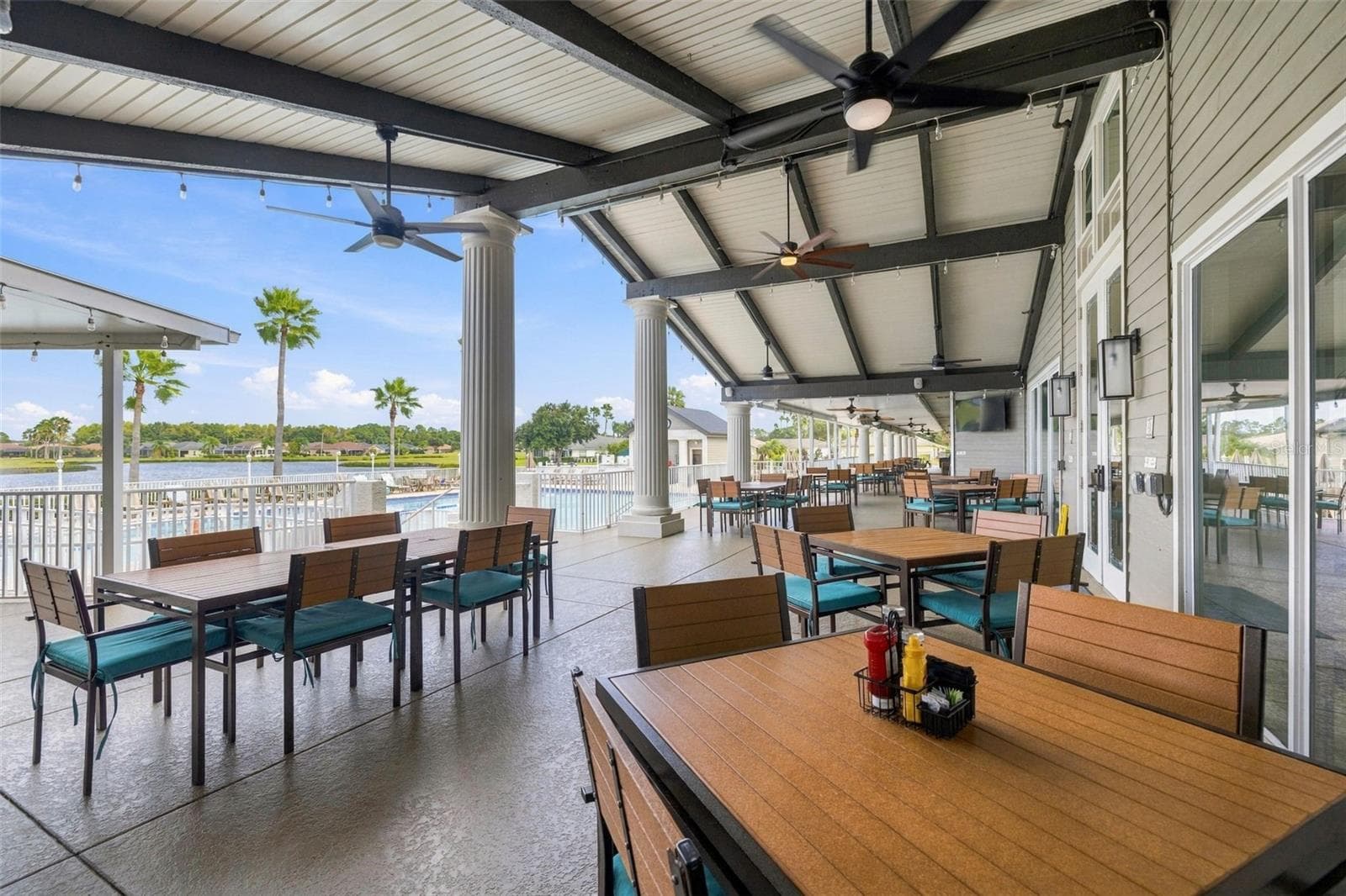 Lots of outdoor/patio seating at the clubhouse overlooking the pool - 1149 WOLFORD DR, NEW PORT RICHEY