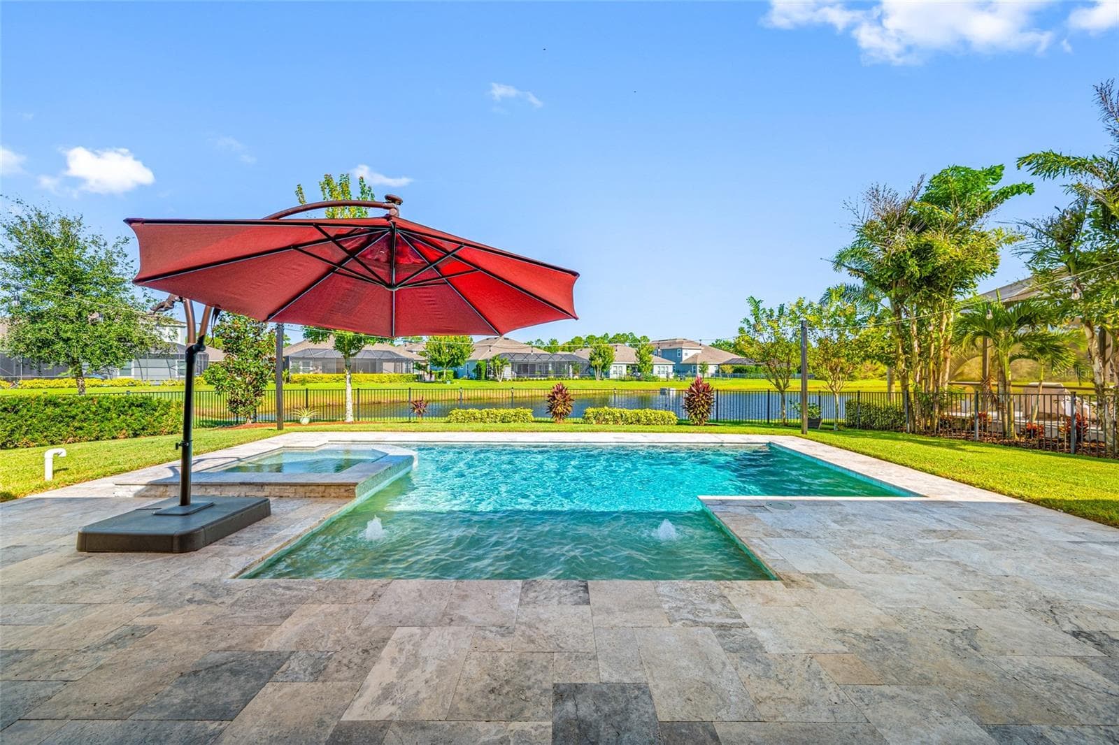Backyard Pool with Infinity edge Spa on pond - 4161 GLADE WOOD LOOP, NEW PORT RICHEY