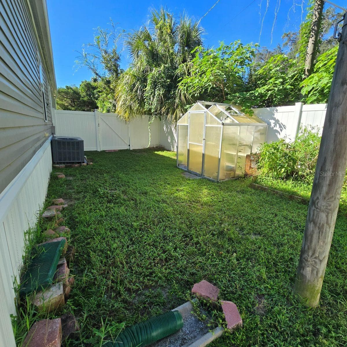 left side of property with green house - 9837 SE 160TH LN, SUMMERFIELD