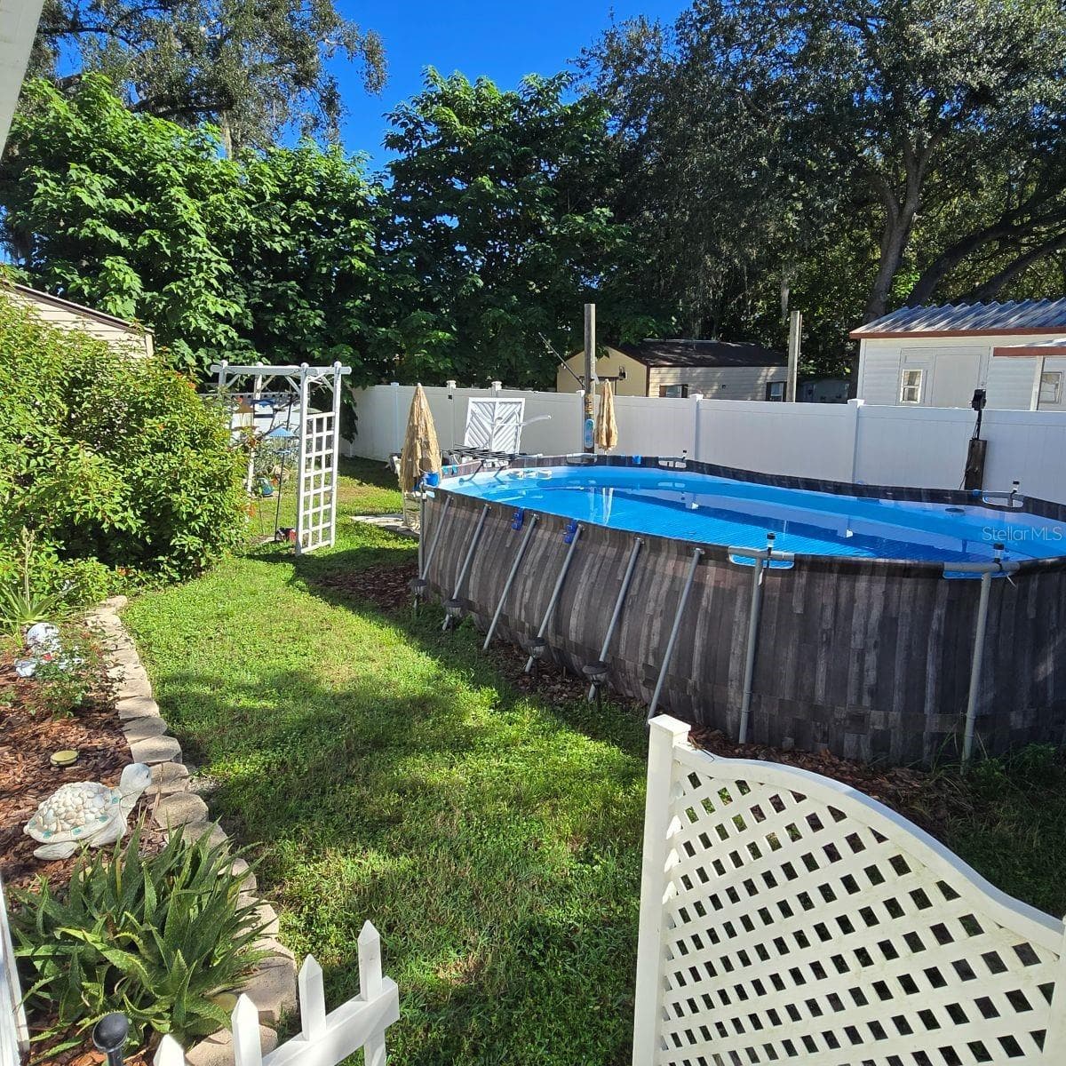 right side of property with above ground pool - 9837 SE 160TH LN, SUMMERFIELD