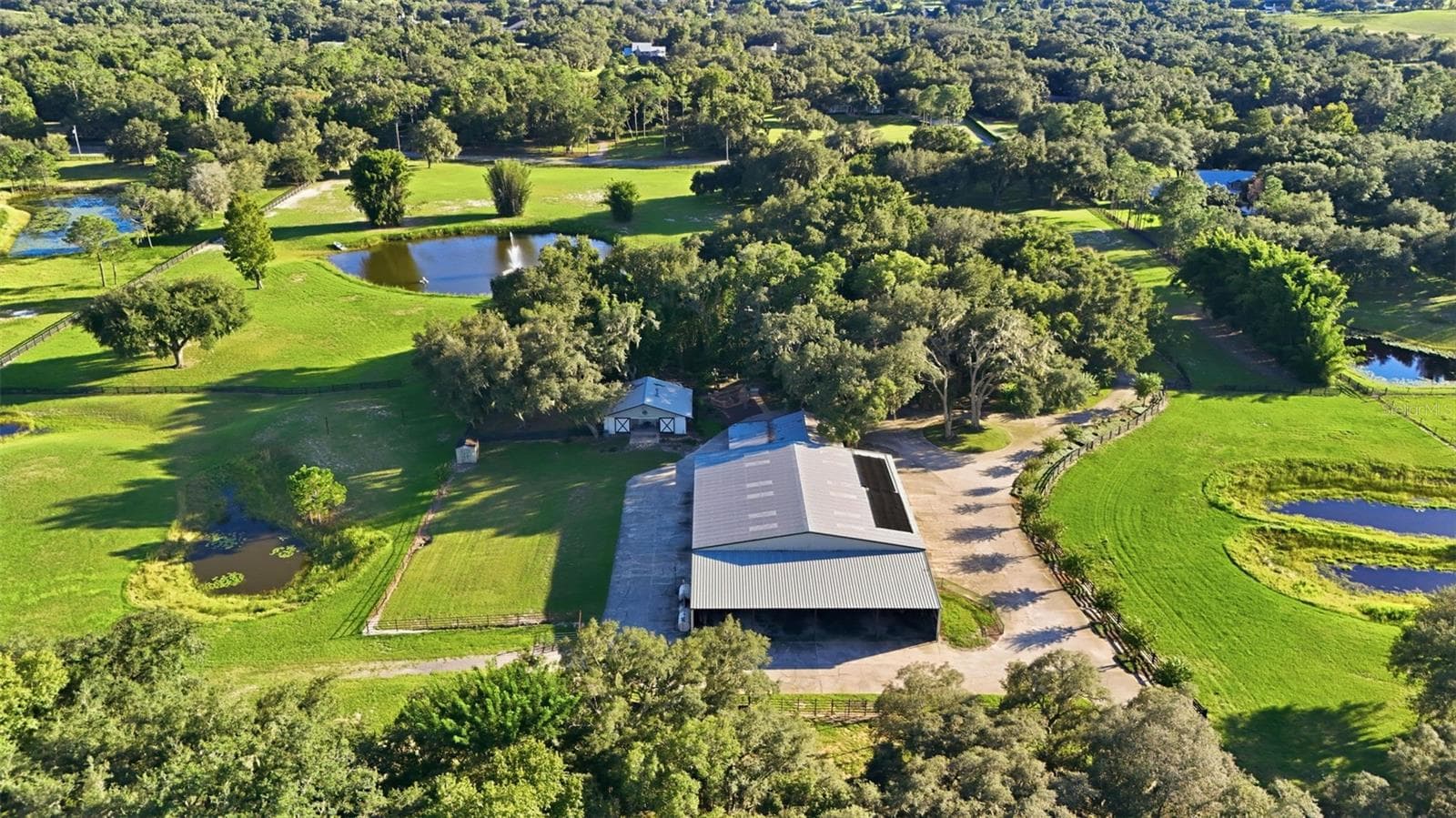 aerial of property, horse barn and front pond with fountain - 15211 VINOLA PL, MONTVERDE