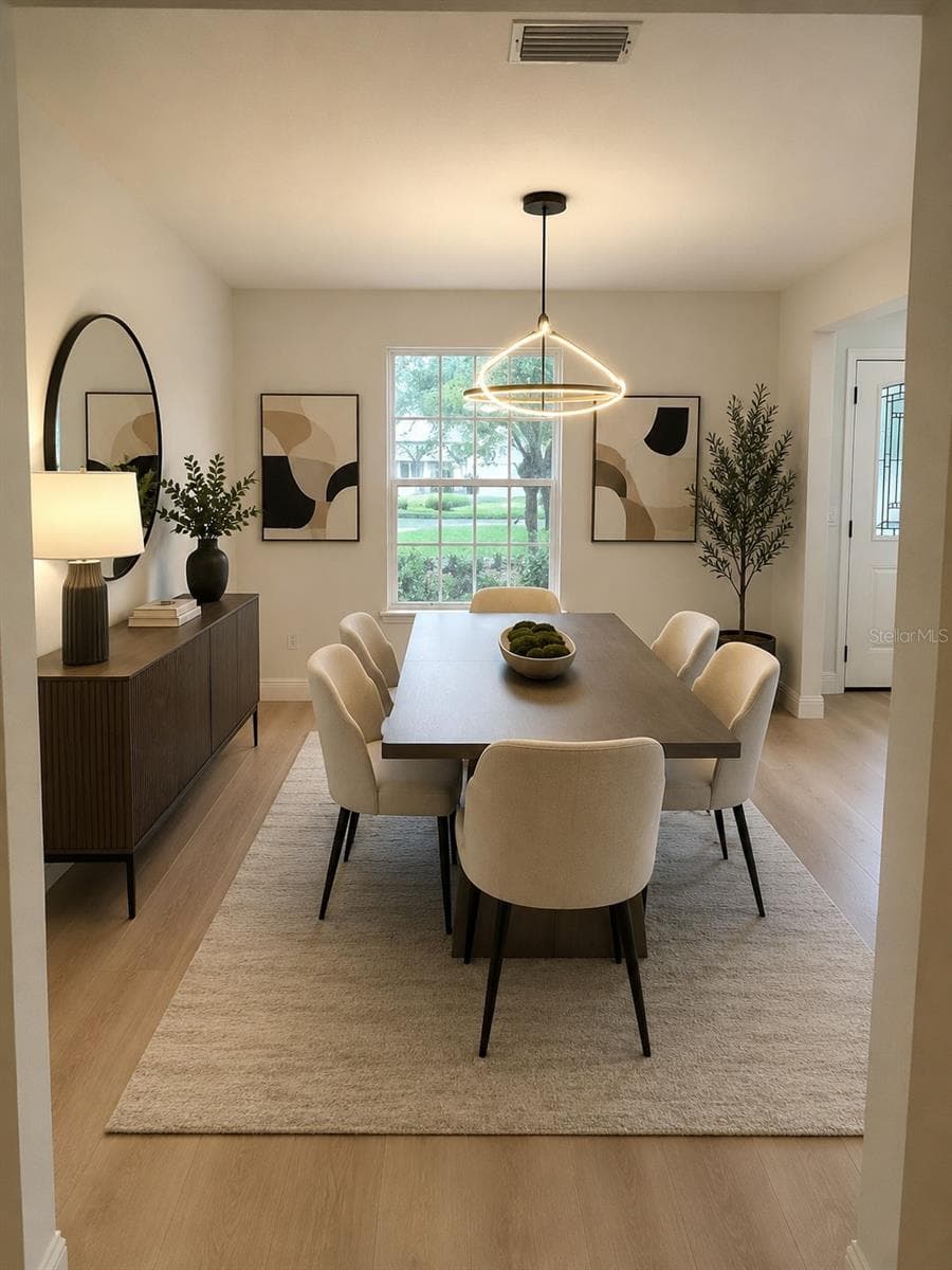 Virtual staged dining room overlooking front yard garden area - 1901 KNOLTON AVE, ORANGE CITY