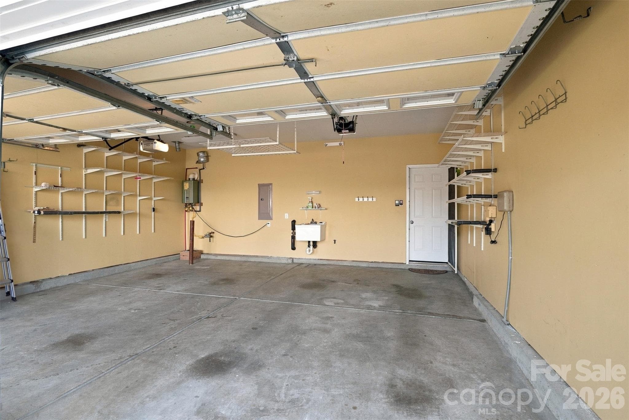Gas tankless water heater in the back left corner! Deep sink in garage for cleaning up! - 608 Goldflower Drive, Rock Hill