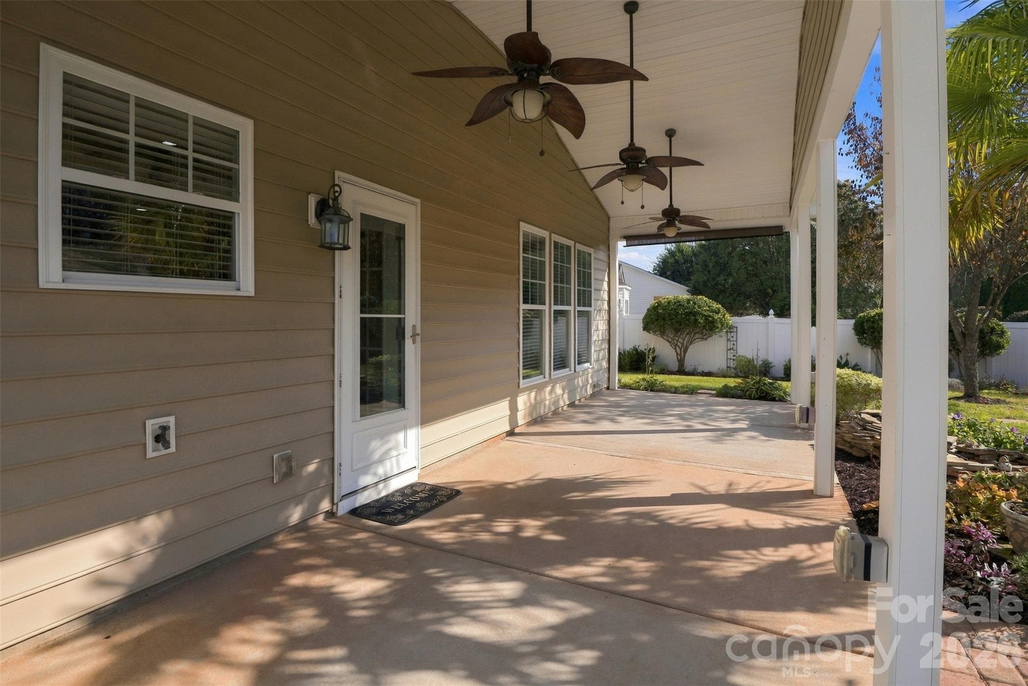 Back covered patio with 3 ceiling fans! Door leads into the kitchen. - 608 Goldflower Drive, Rock Hill
