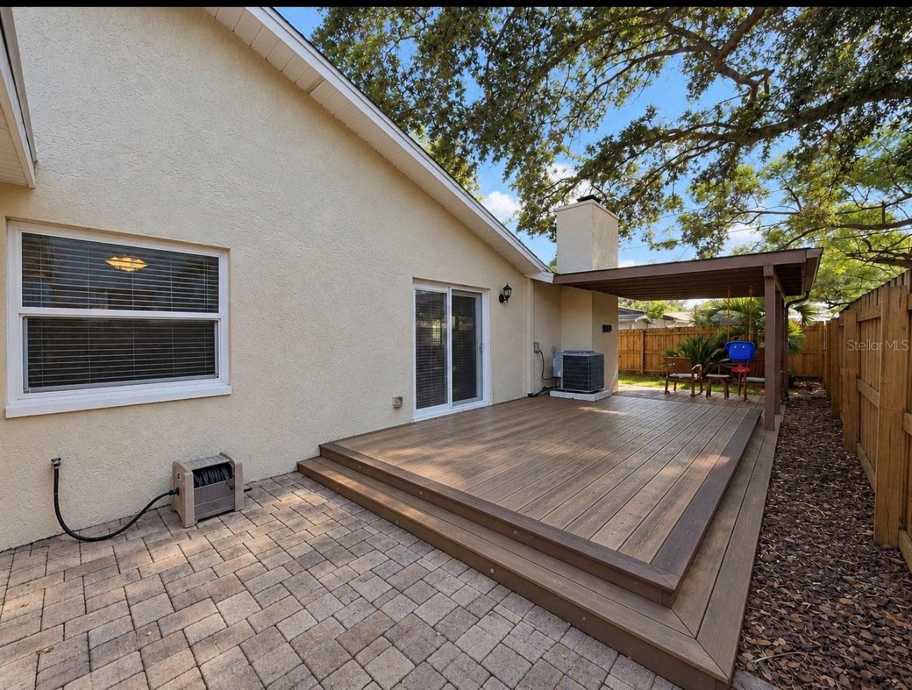 paver side of home with entertainment deck - 1231 ROSEWOOD ST, LARGO