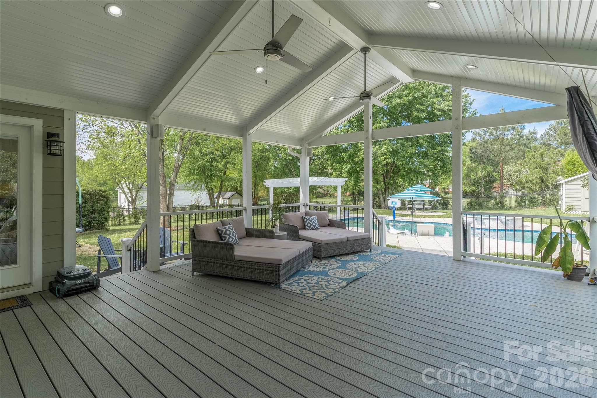 Enter your backyard oasis and enjoy cool summer nights on the large Trex covered patio overlooking the pool - 16647 Greenfarm Road, Huntersville