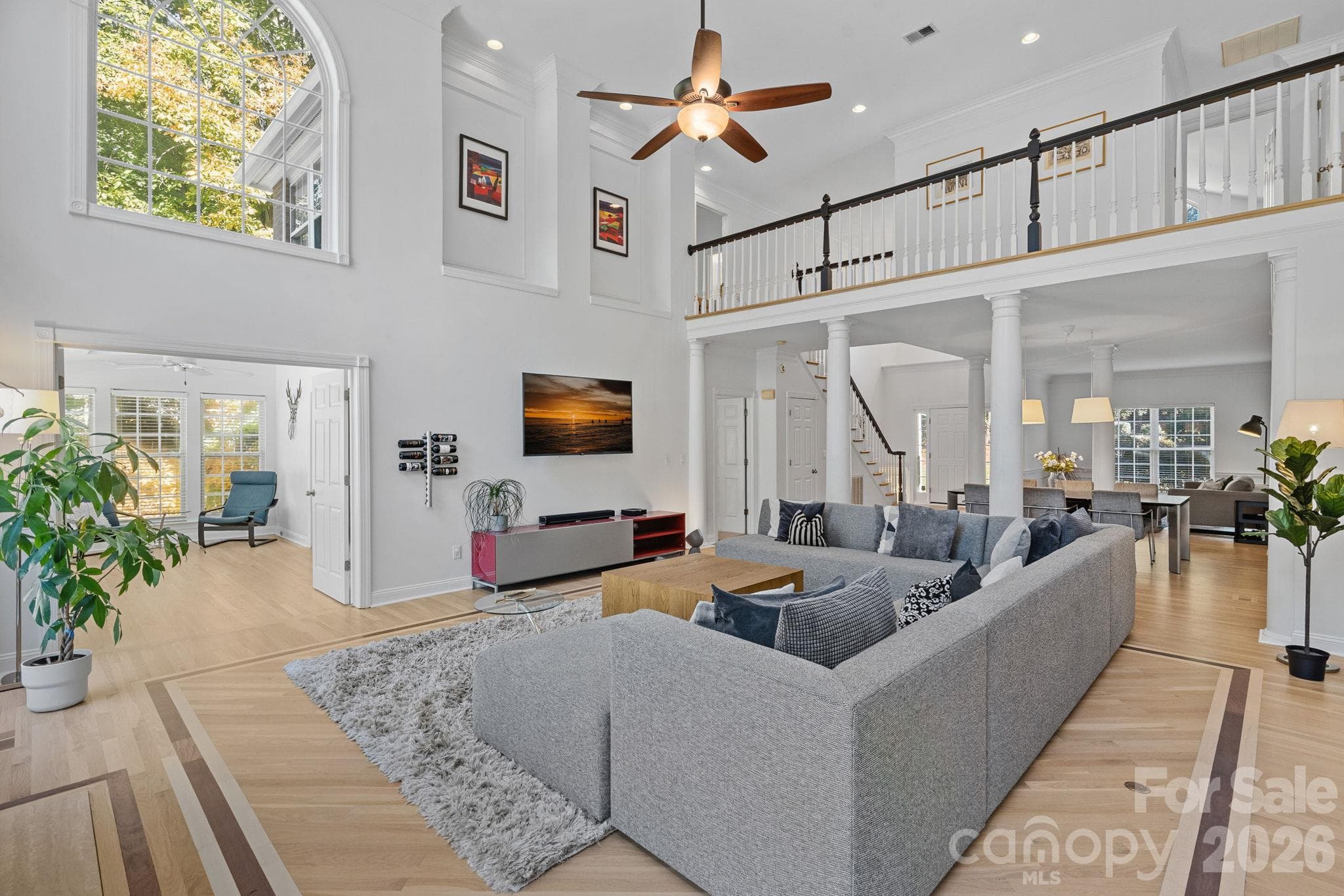 Looking back from the living room toward the dining room & sitting room. Sun room of Primary Suite is to the left - 148 Sunrise Circle, Mooresville
