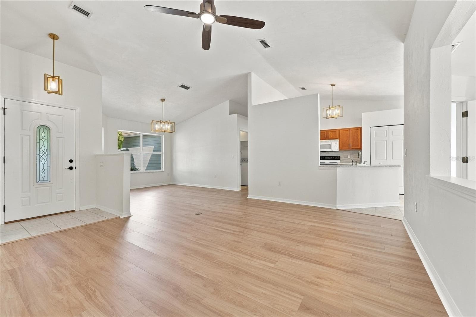 Family Room looking into Dining Room and Kitchen - 1055 NW 89TH DR, GAINESVILLE
