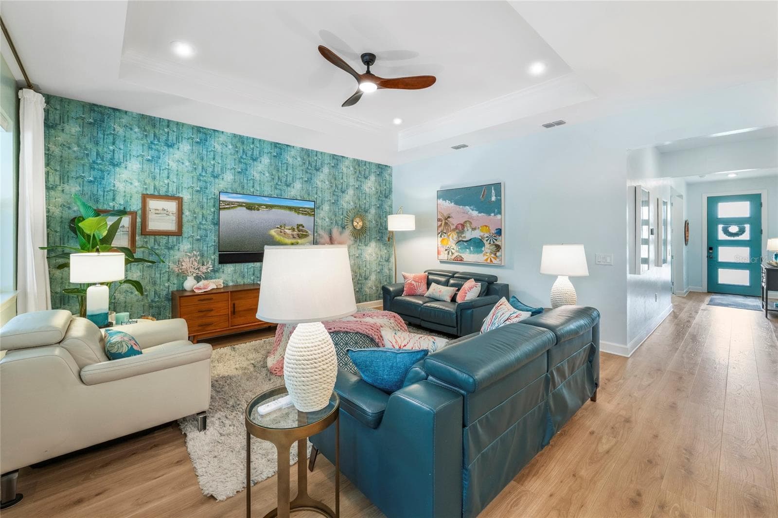 Living Room complete with views of the Pool and Impact Glass Front Door! - 5437 SILVERSIDE PINE CT, LAKEWOOD RANCH