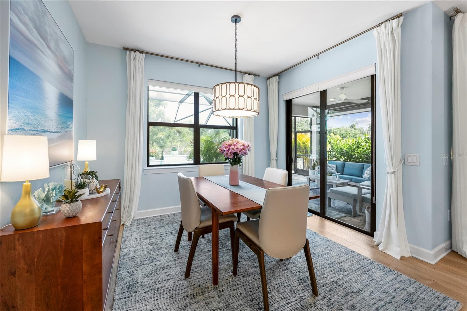 Dining room complete with chandelier and Pool access! - 5437 SILVERSIDE PINE CT, LAKEWOOD RANCH